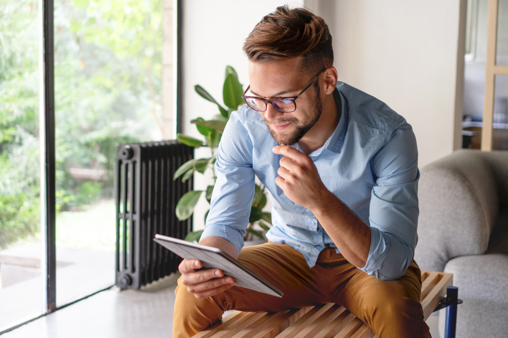 man looking at social media on tablet